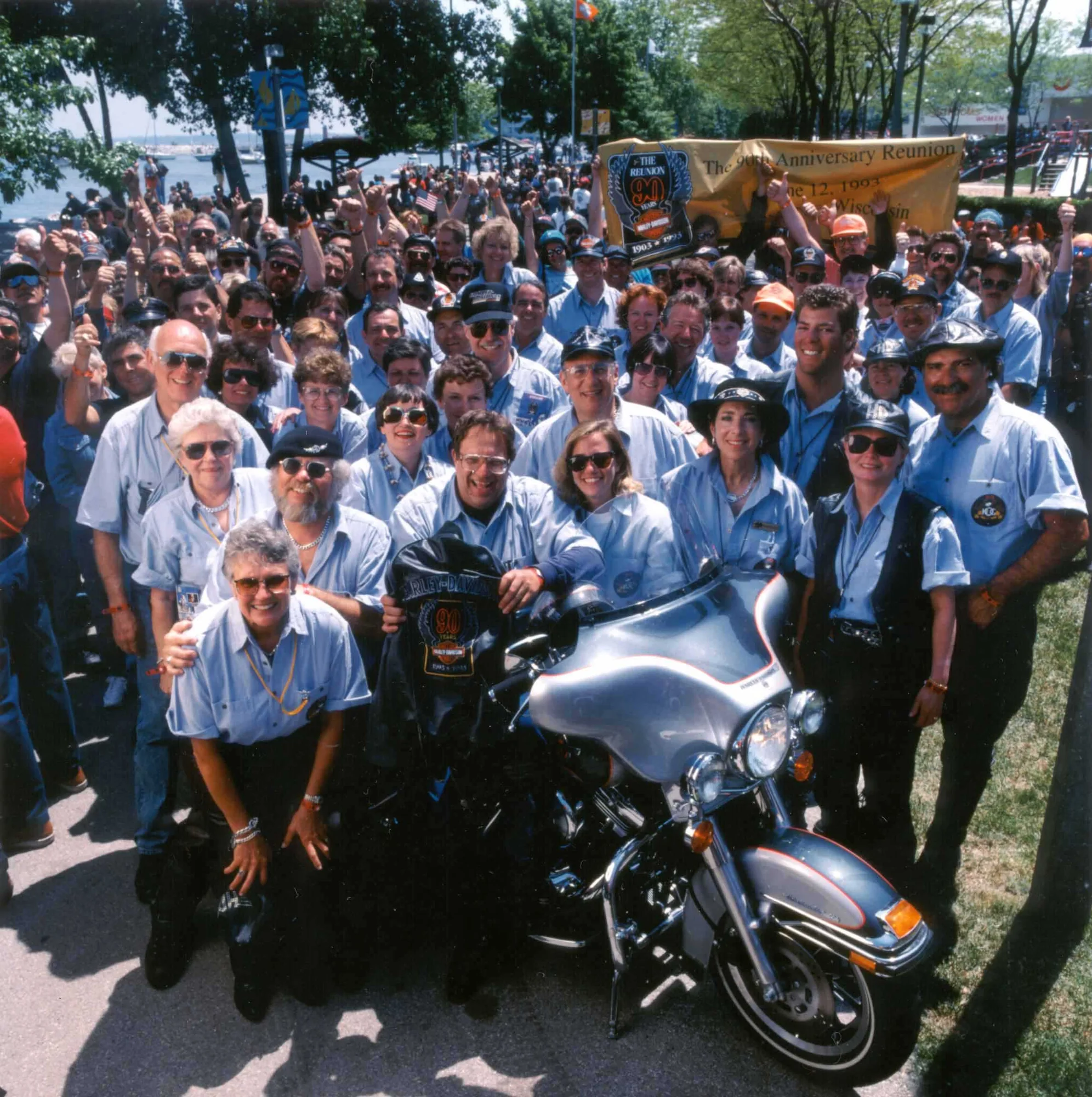 Large employee group with a Harley-Davidson motorcycle