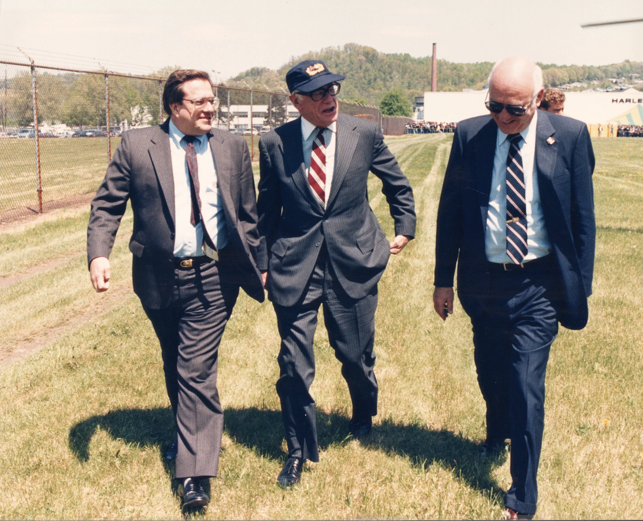 Malcolm Forbes with Rich Teerlink and Vaughn Beals, walking on the lawn around the York facility. Image taken during President Ronald Reagan's York, PA visit.