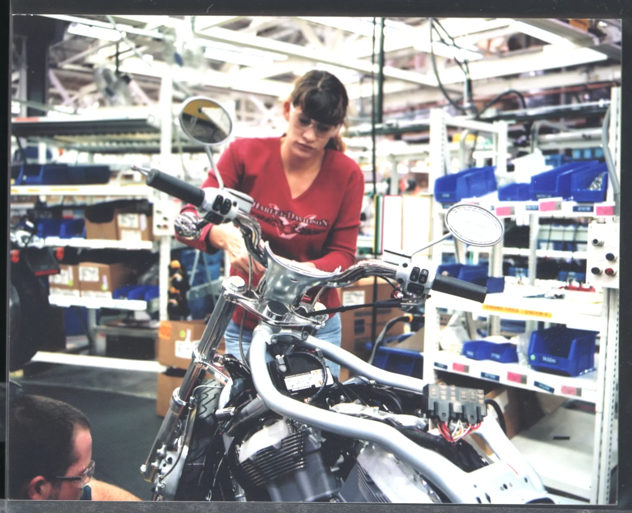 Harley-Davidson employee assembling a motorcycle on the factory floor