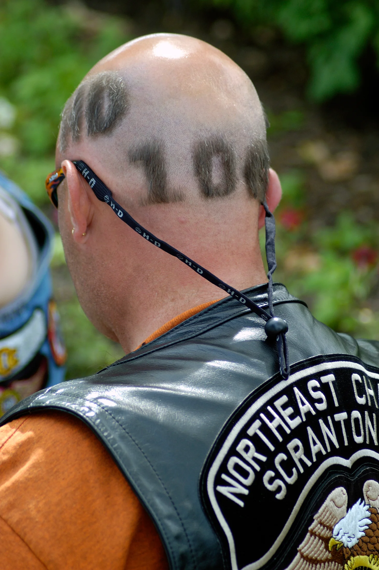 Rider with 100 shaved in hair and chapter vest
